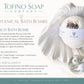Tofino Soap Company Beach Bath Bomb package design with a white bath bomb, dried botanicals, a small jar, and descriptive text on a soft beige background.