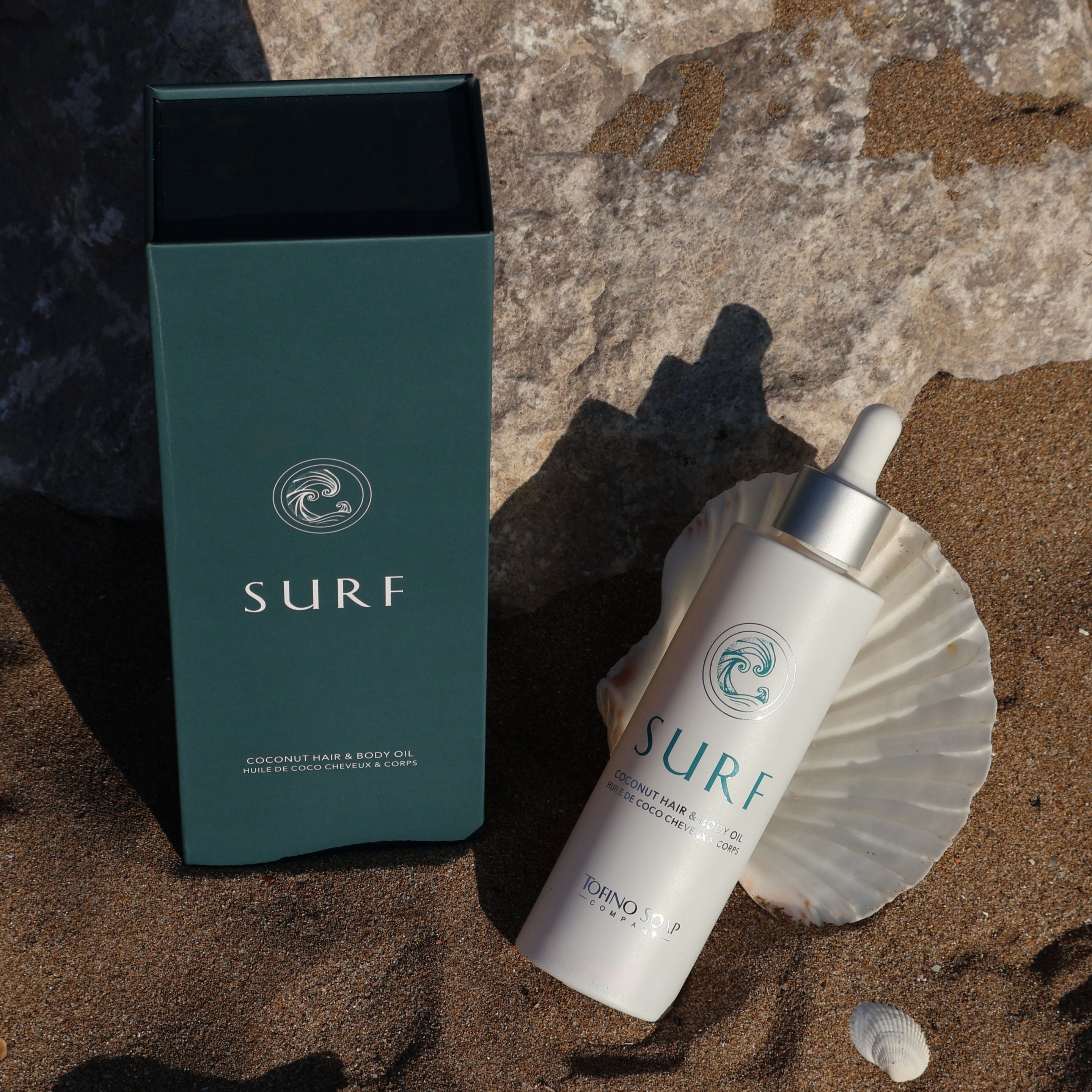 SURF product packaging on a beach setting with a shell and natural elements.