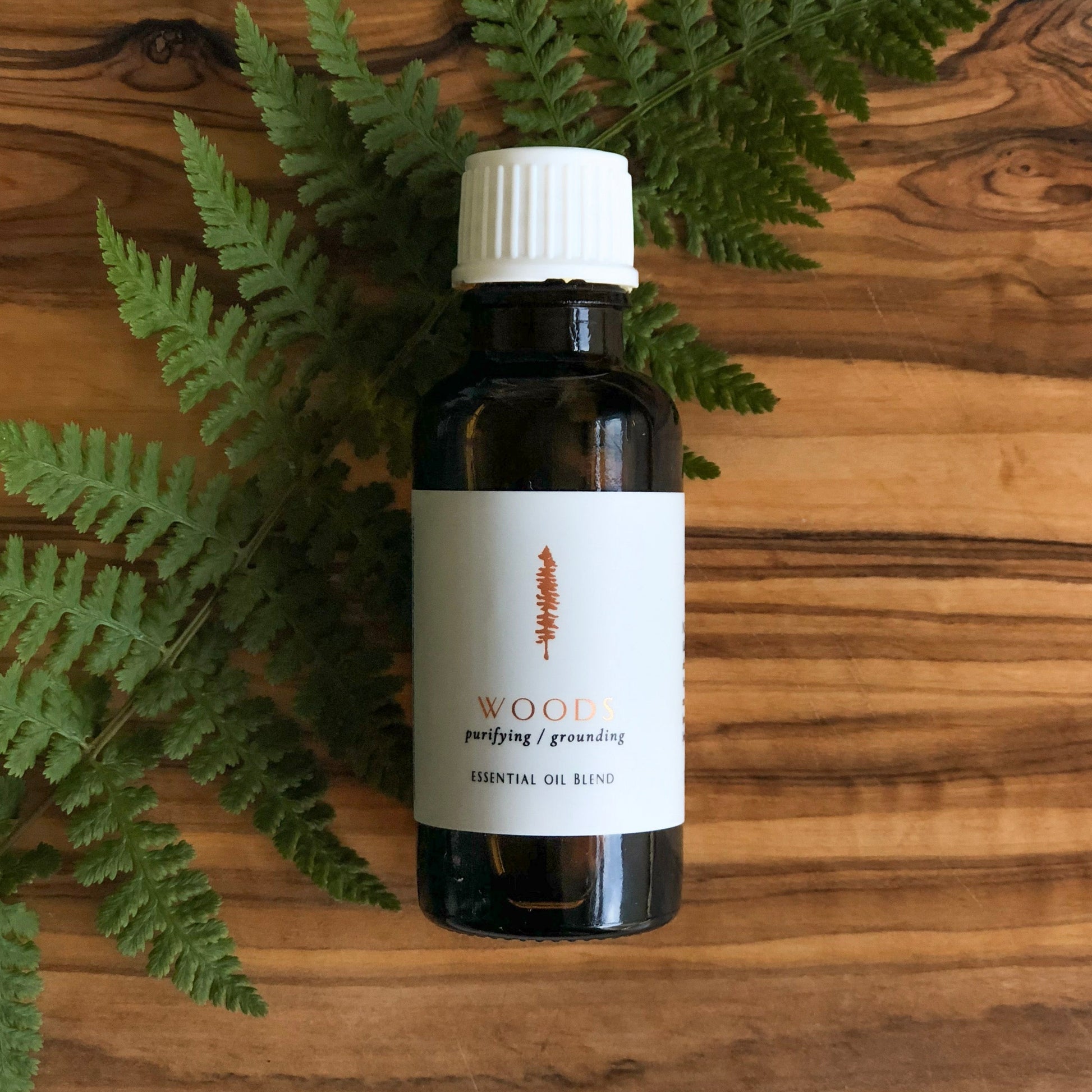Woods essential oil blend in amber bottle, by Tofino Soap Company